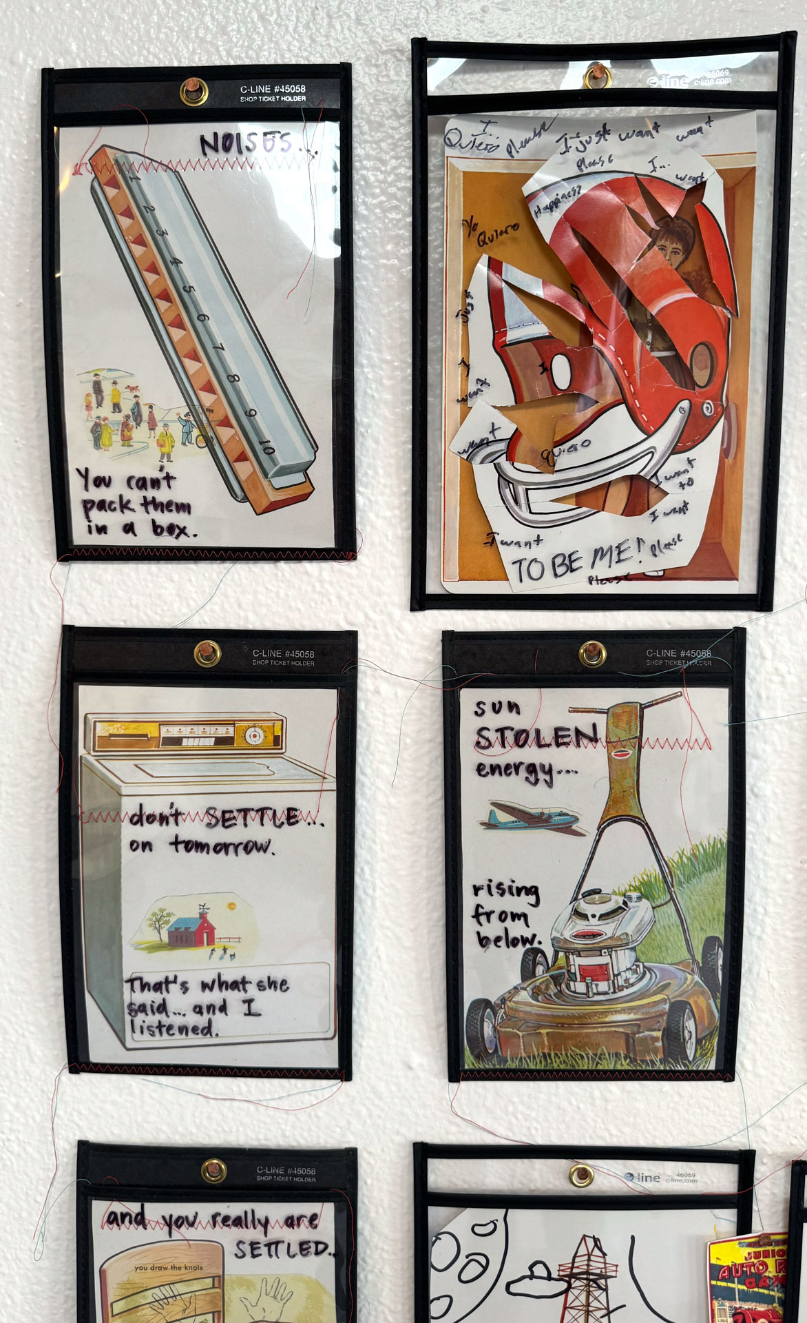 installation with wood table cut in half against wall, job folder, collage materials, audience participation
