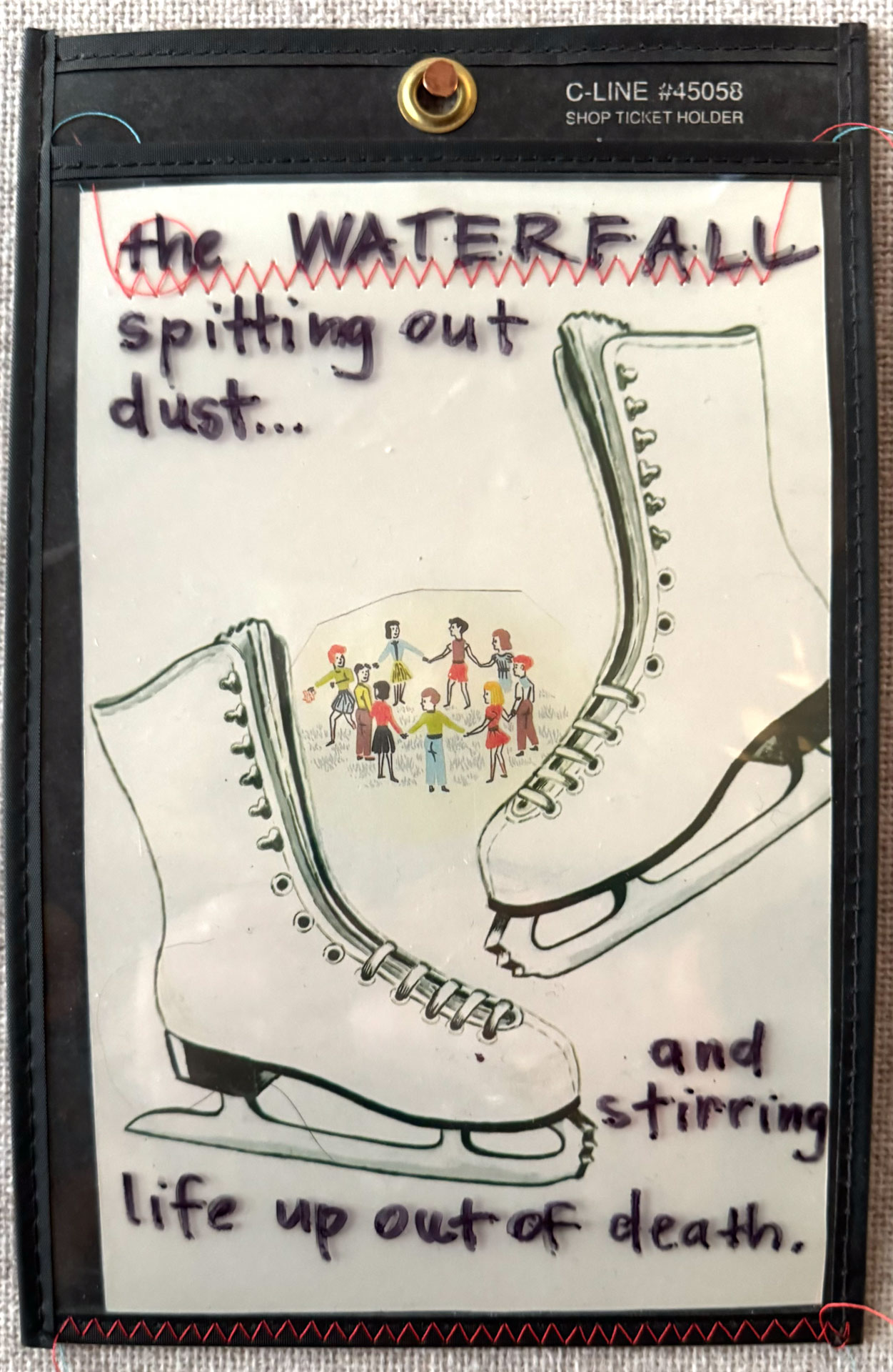 installation with wood table cut in half against wall, job folder, collage materials, audience participation