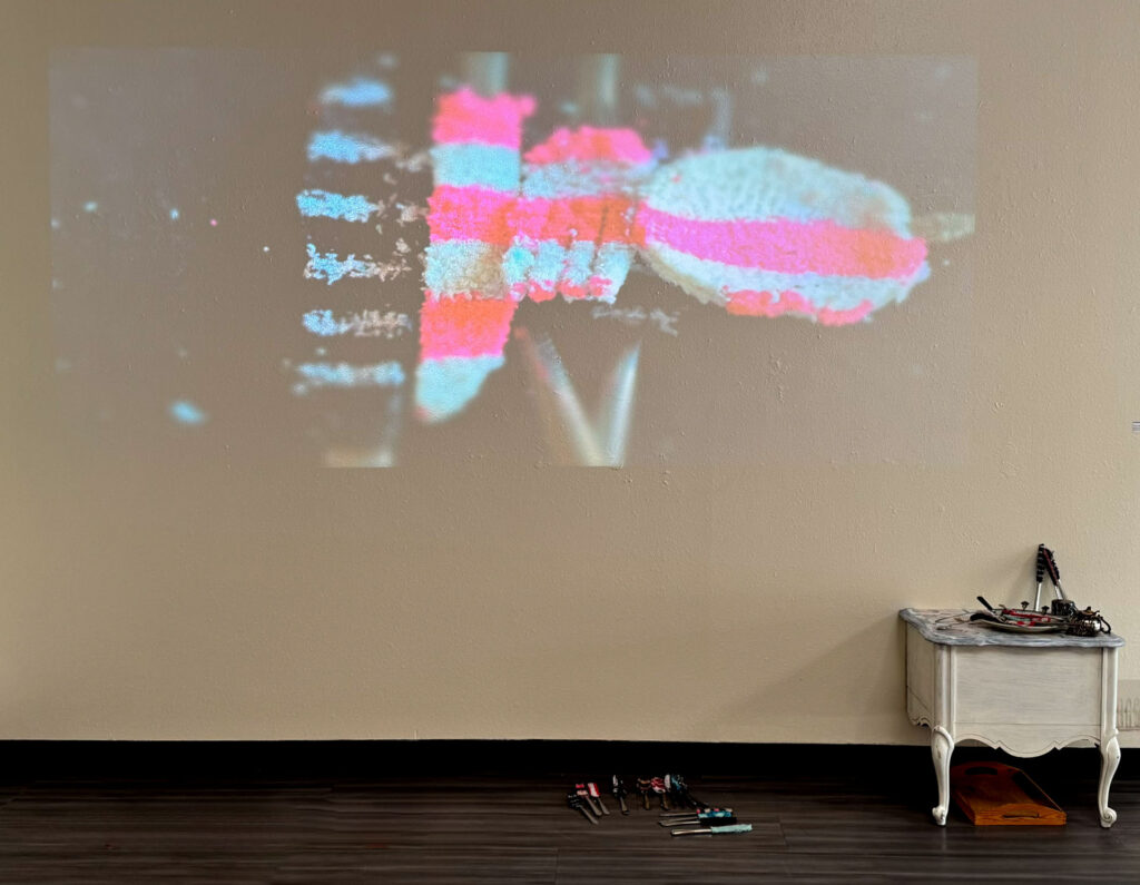 video installation of moving silver utensils with cloth 
