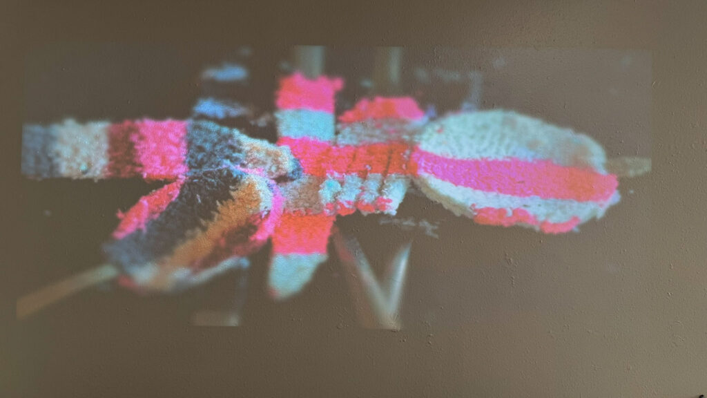 video installation of moving silver utensils with cloth